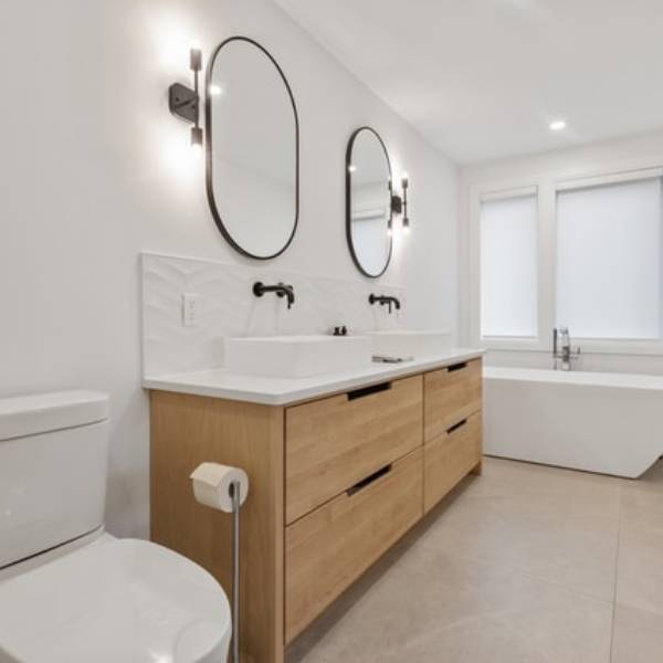 Bathroom with two taps and beautiful ellipsoidal mirrors